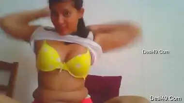 Cute possessor of natural Desi tits puts on clothes in front of camera