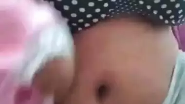 Indian MILF looks into the camera showing that she has XXX boobs